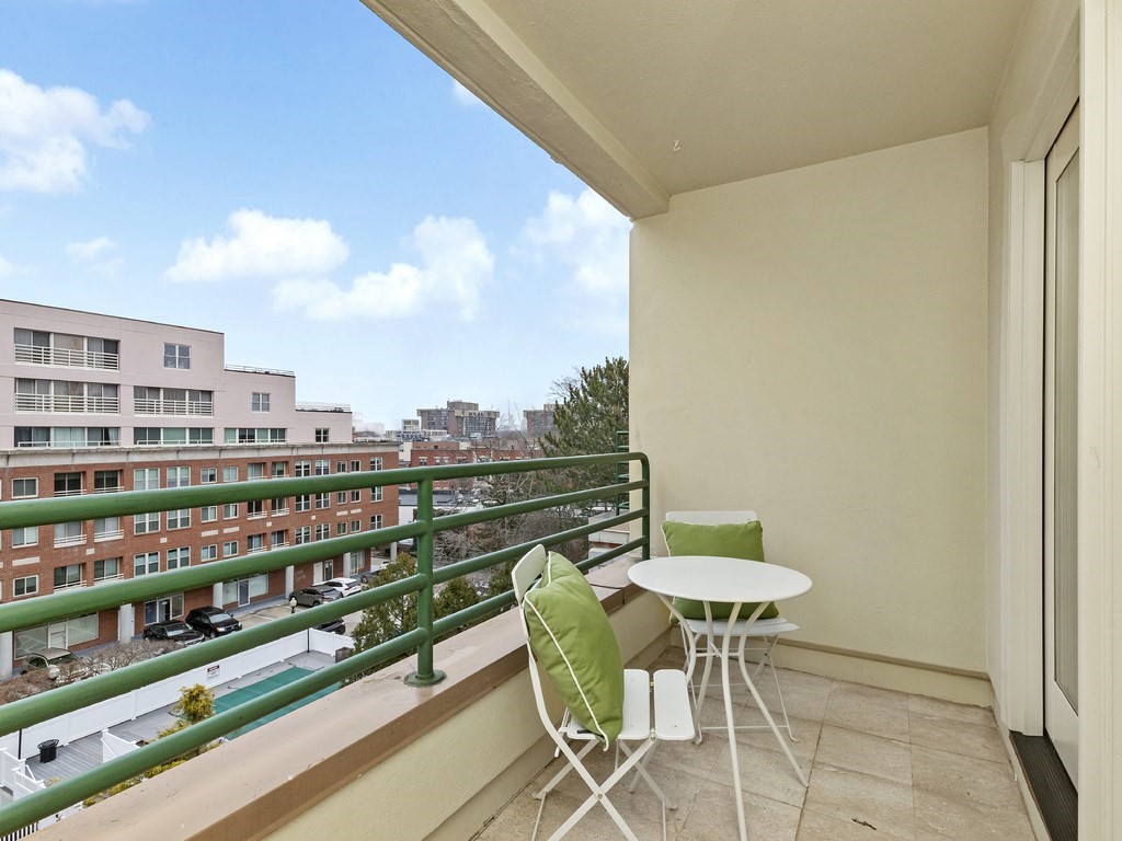25 Marion Street, Unit PH3 Brookline, MA 02446 - Photo 15 of 22 a balcony with table and chairs