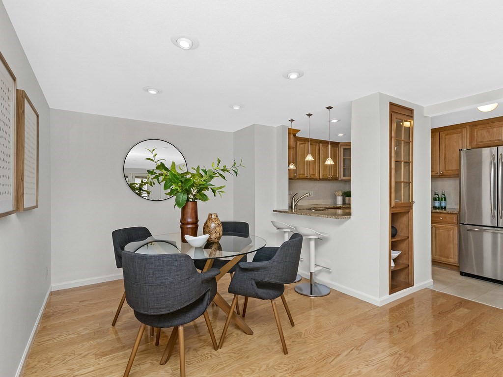 25 Marion Street, Unit PH3 Brookline, MA 02446 - Photo 4 of 22 a dining room with furniture and a chandelier