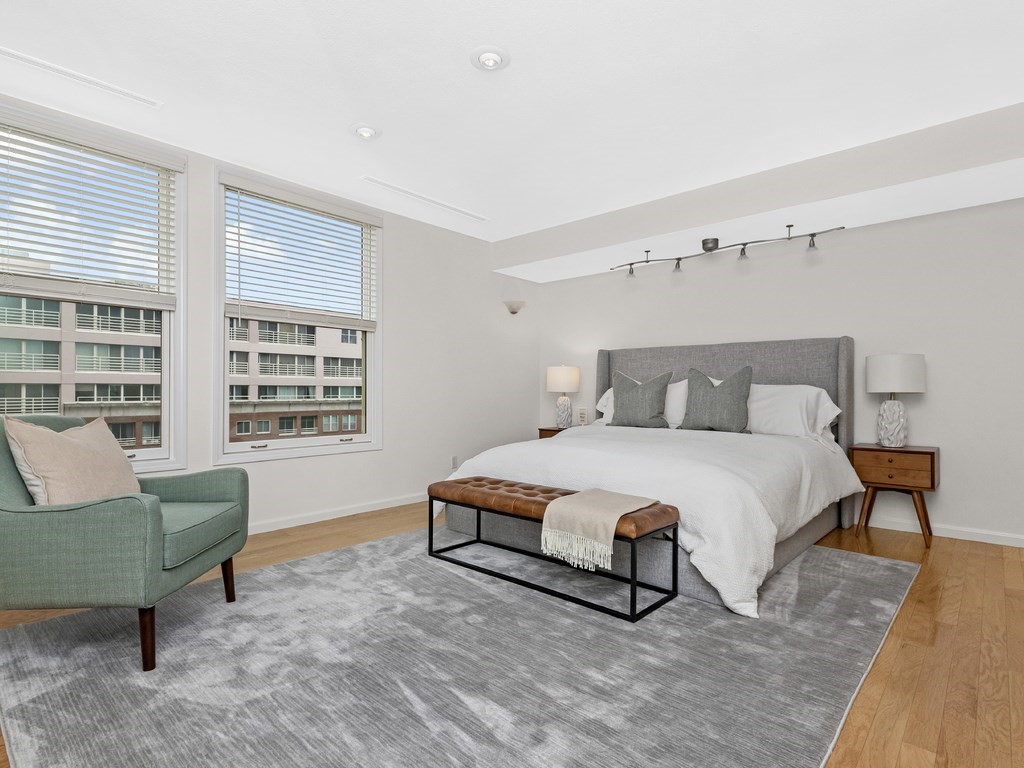 25 Marion Street, Unit PH3 Brookline, MA 02446 - Photo 8 of 22 a bedroom with a bed a table and chair
