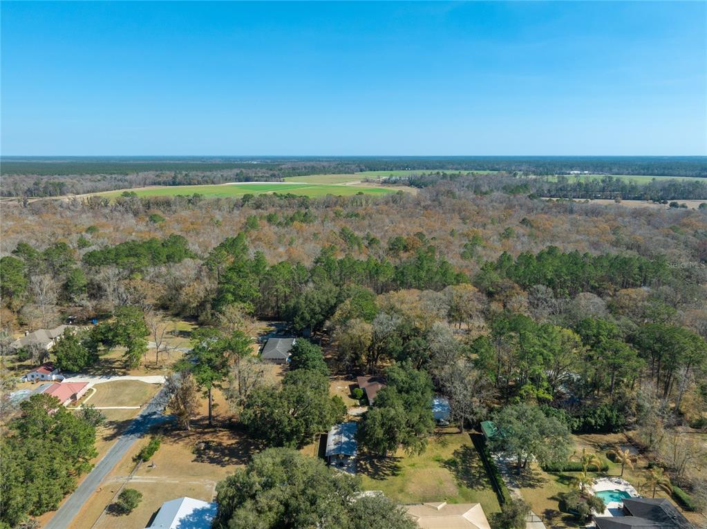 Fouracre Circle Callahan, FL 32011 - Photo 11 of 31 an aerial view of a city with lots of residential buildings and mountain view in back