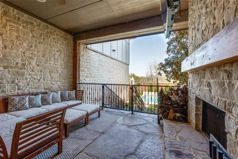 a balcony with furniture and a fireplace