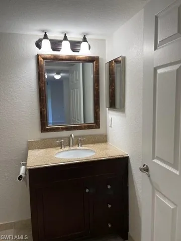 a bathroom with a double vanity sink and mirror