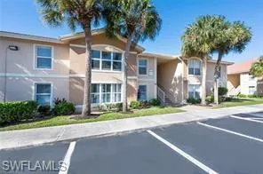 a front view of a house with a yard and a garage