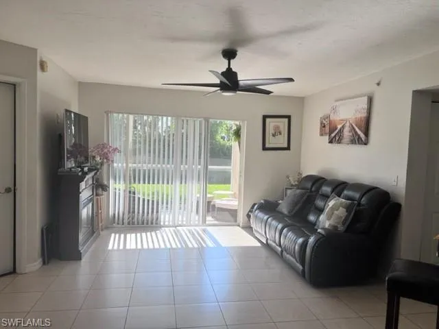 a living room with furniture and a ceiling fan
