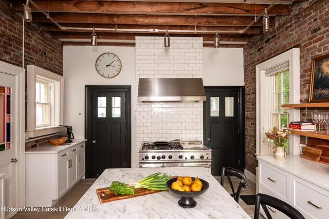 a kitchen with a stove and a clock on the wall