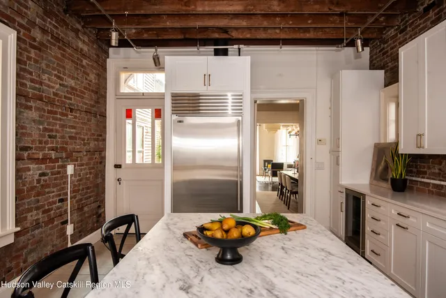 a kitchen with stainless steel appliances kitchen island granite countertop a refrigerator and a stove