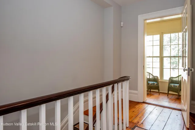 a view of a room with wooden floor and furniture