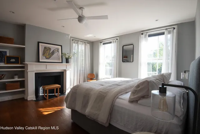 a bedroom with a bed and a fireplace