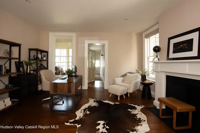a living room with furniture wooden floor and a fireplace