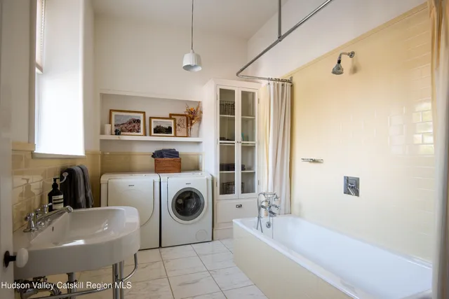 a bathroom with a sink a bathtub and shower