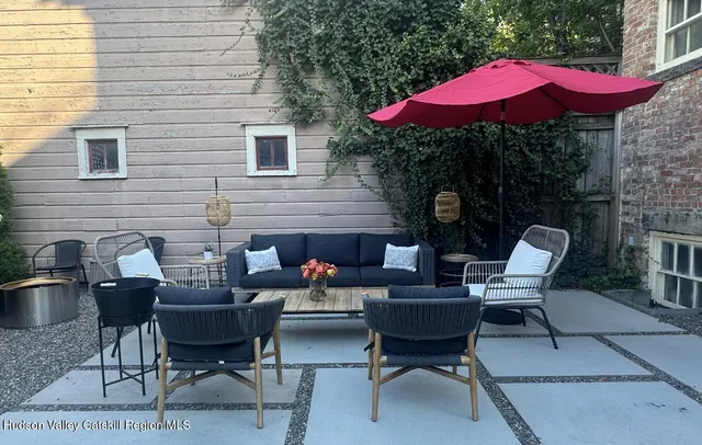 a backyard of a house with table and chairs