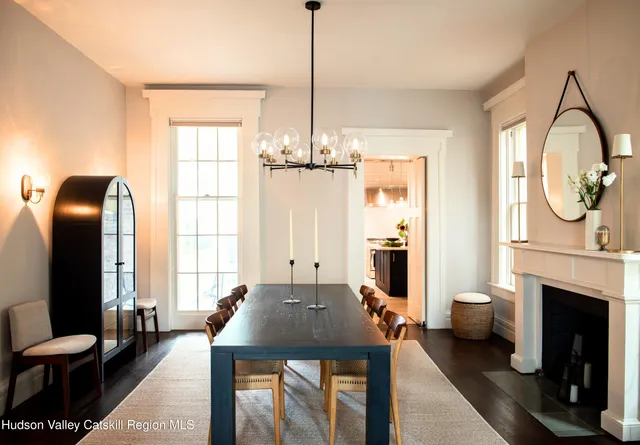 a living room with furniture a fireplace and a chandelier