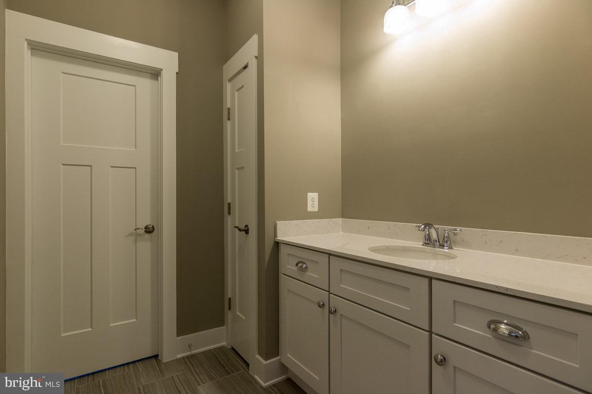 3100 Thurston Road Frederick, MD 21704 - Photo 25 of 35 a bathroom with a granite countertop sink and mirror
