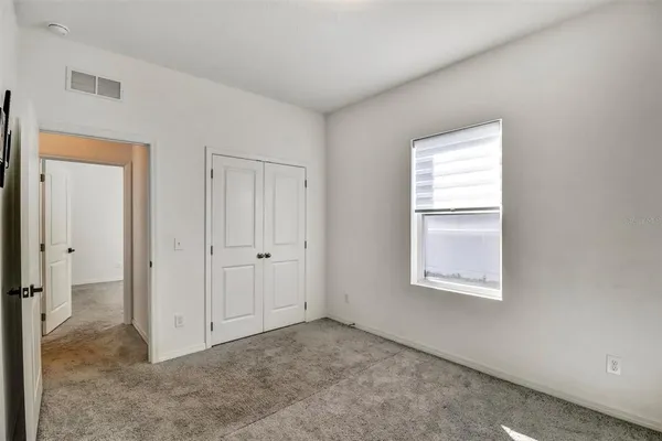 a view of an empty room and a window