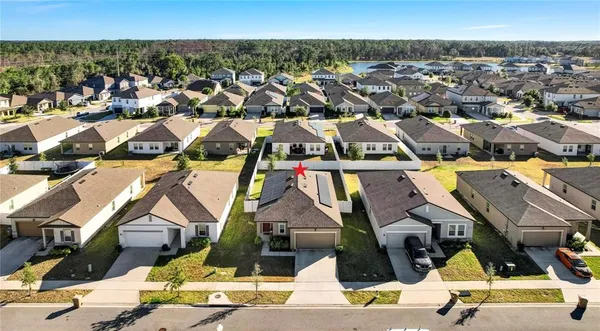 an aerial view of a house with swimming pool