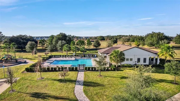 an aerial view of residential houses with outdoor space and swimming pool