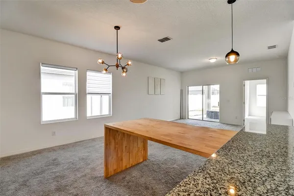 a kitchen with stainless steel appliances granite countertop a stove microwave and sink