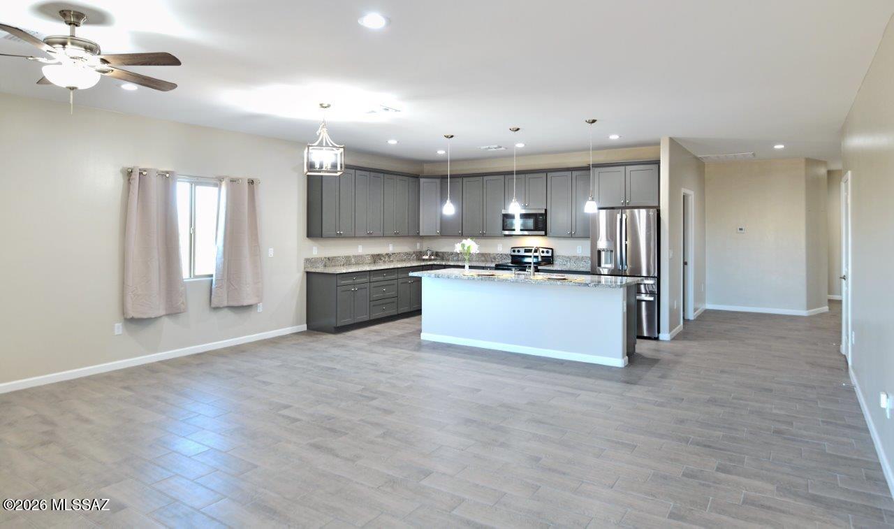 1091 North Vail View Road Vail, AZ 85641 - Photo 6 of 43 a large kitchen with a refrigerator and a stove top oven
