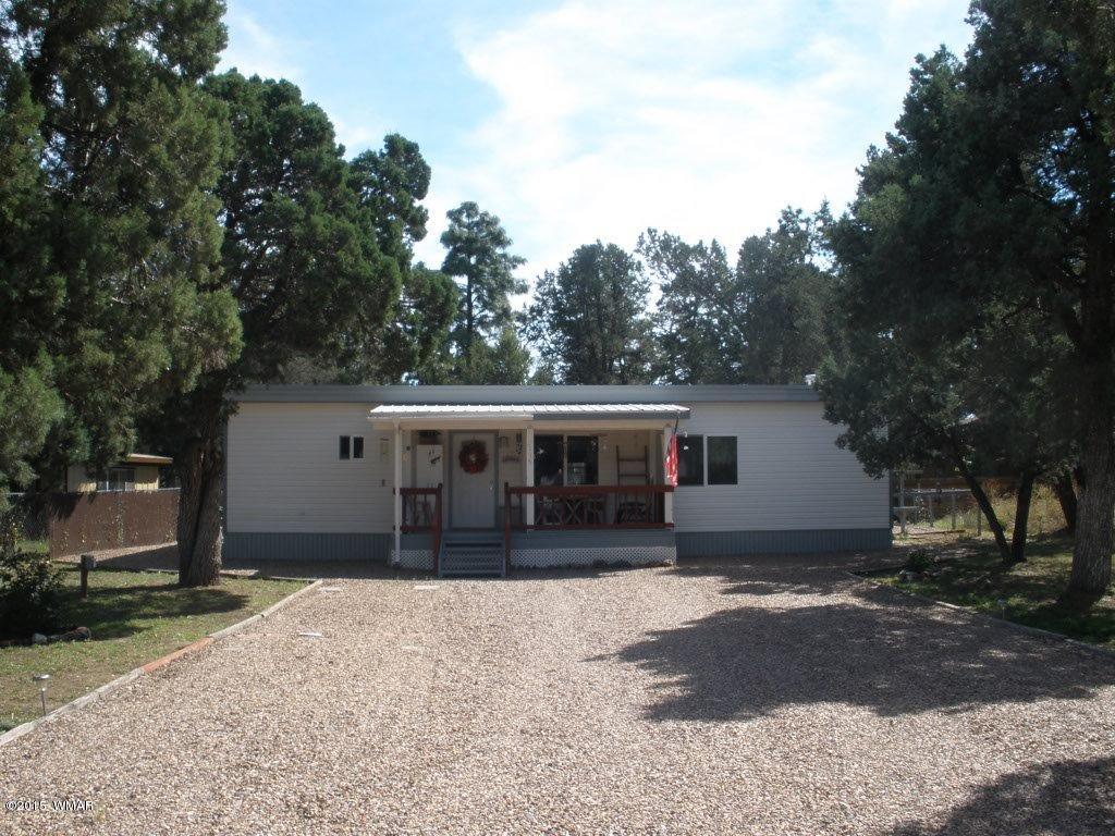 2135 Wildflower Road Overgaard, AZ 85933 - Photo 4 of 44 a house with trees in the background