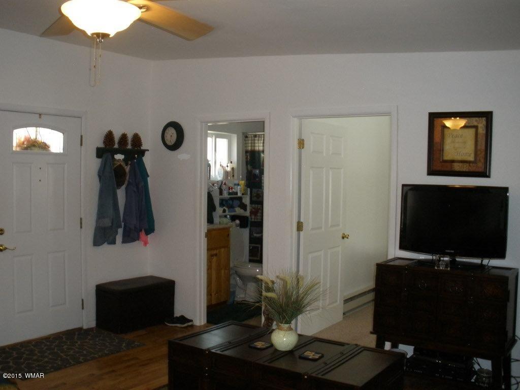 2135 Wildflower Road Overgaard, AZ 85933 - Photo 9 of 44 a living room with furniture and a flat screen tv