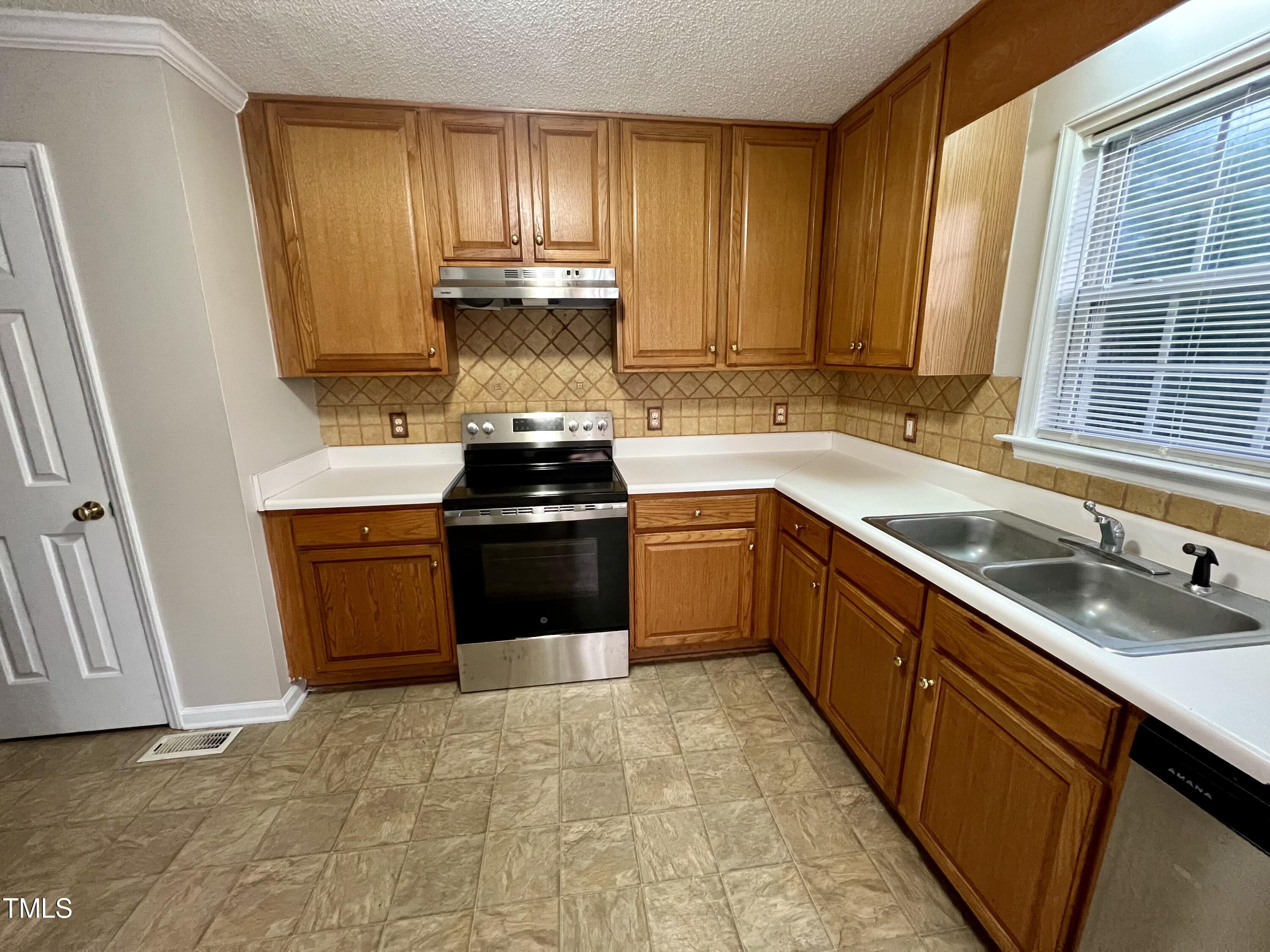 1312 Harvey Johnson Road Raleigh, NC 27603 - Photo 11 of 29 a kitchen with a sink stove and cabinets