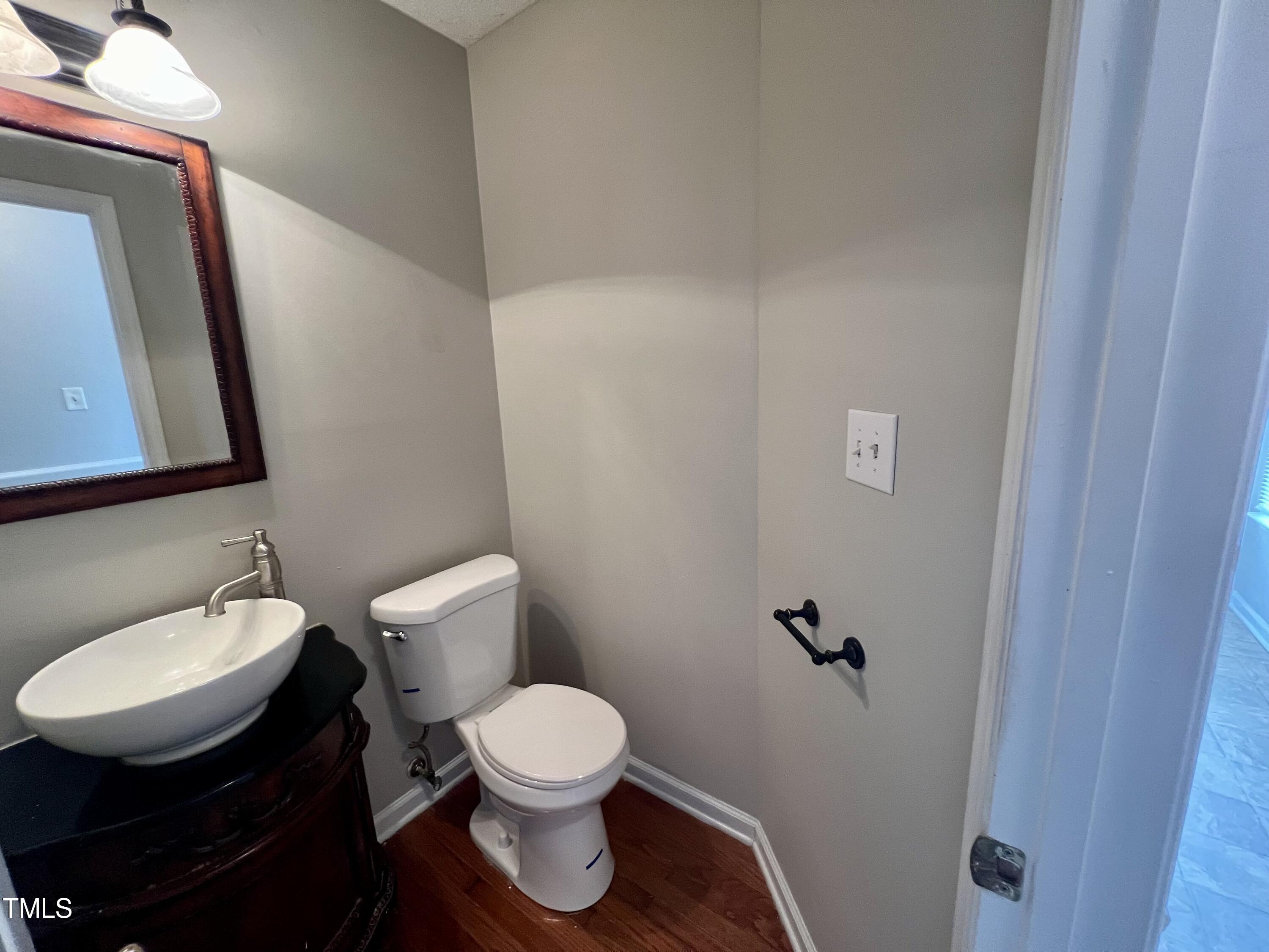 1312 Harvey Johnson Road Raleigh, NC 27603 - Photo 13 of 29 a white toilet sitting next to a bathroom sink