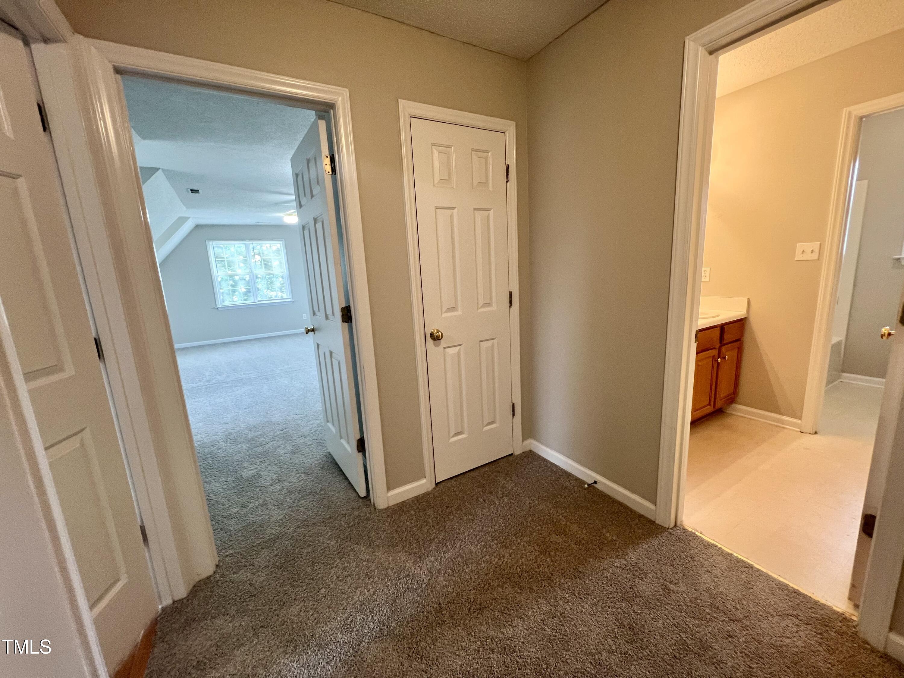 1312 Harvey Johnson Road Raleigh, NC 27603 - Photo 14 of 29 an empty room and a bathroom with mirror