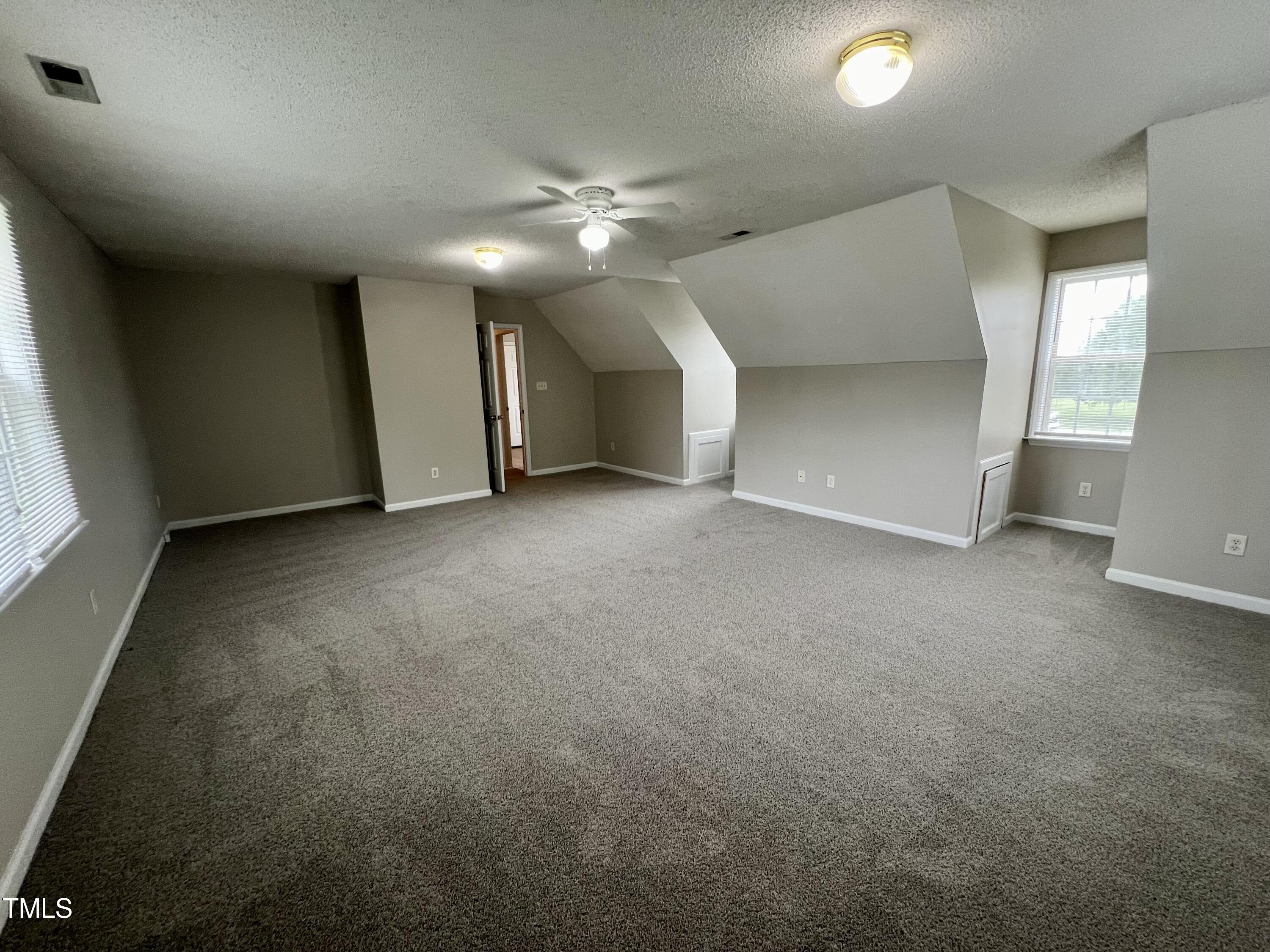 1312 Harvey Johnson Road Raleigh, NC 27603 - Photo 18 of 29 an empty room with a ceiling fan and a window