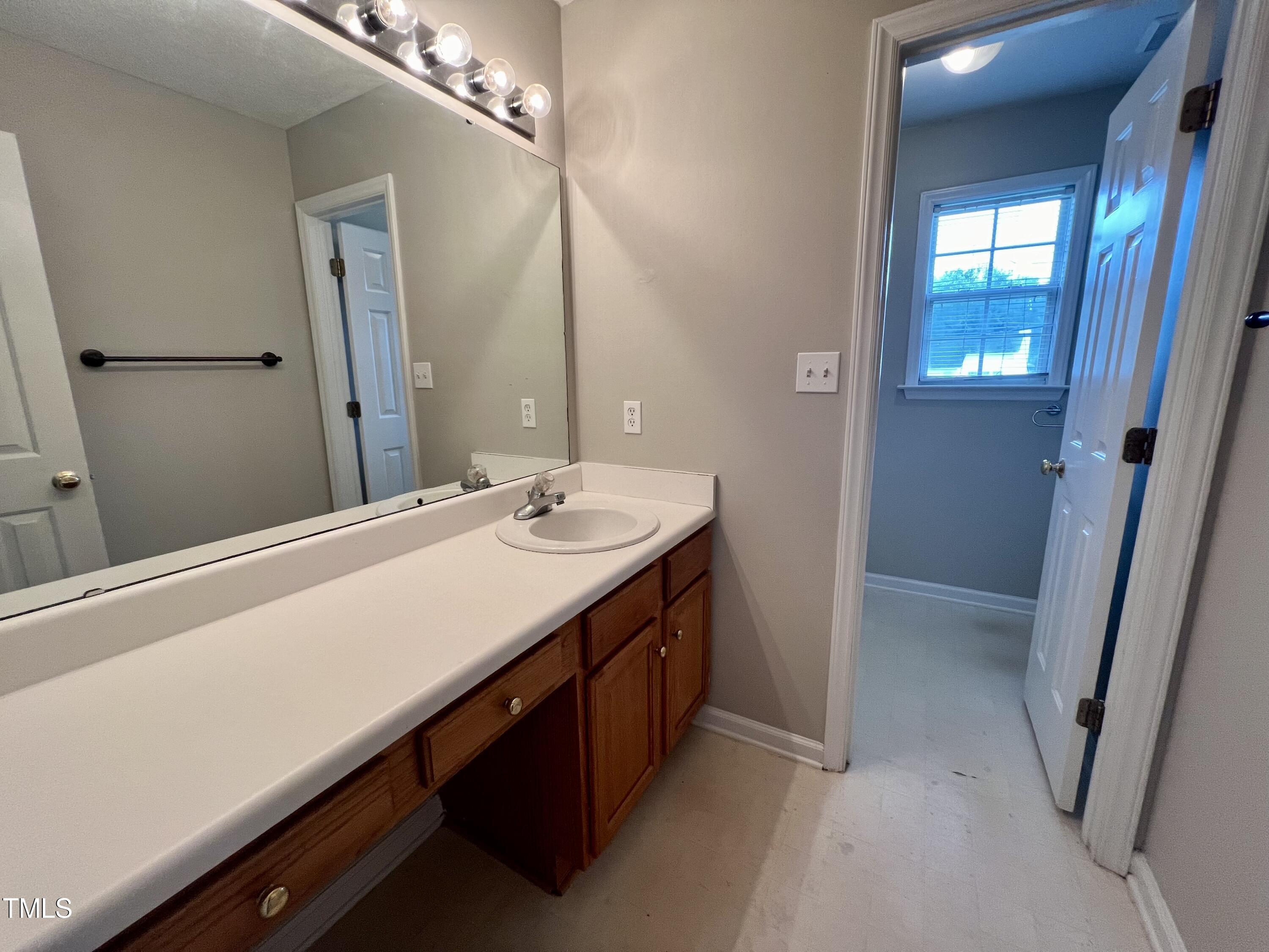 1312 Harvey Johnson Road Raleigh, NC 27603 - Photo 19 of 29 a bathroom with a double vanity sink and a mirror
