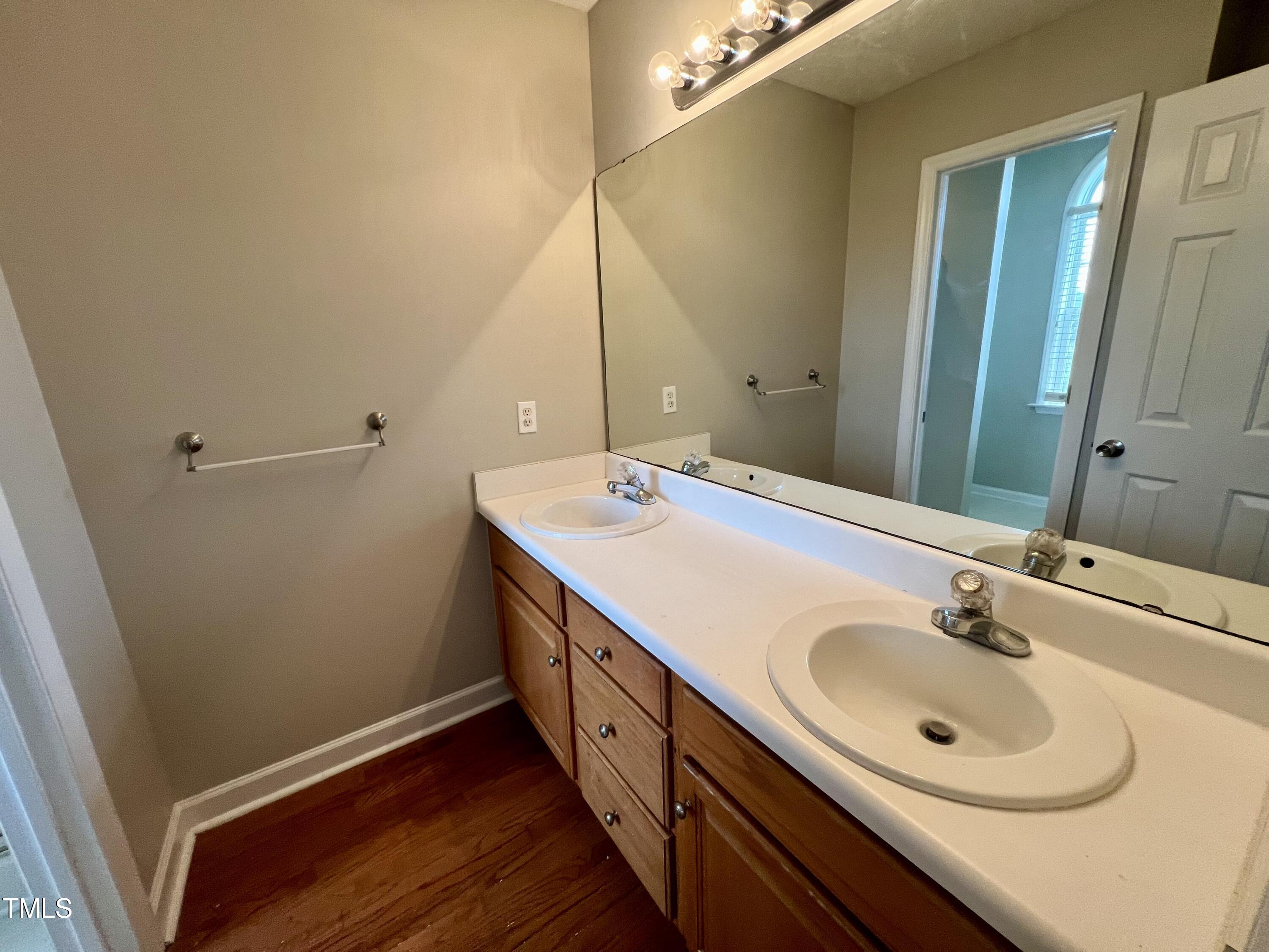1312 Harvey Johnson Road Raleigh, NC 27603 - Photo 25 of 29 a bathroom with a double vanity sink and a mirror