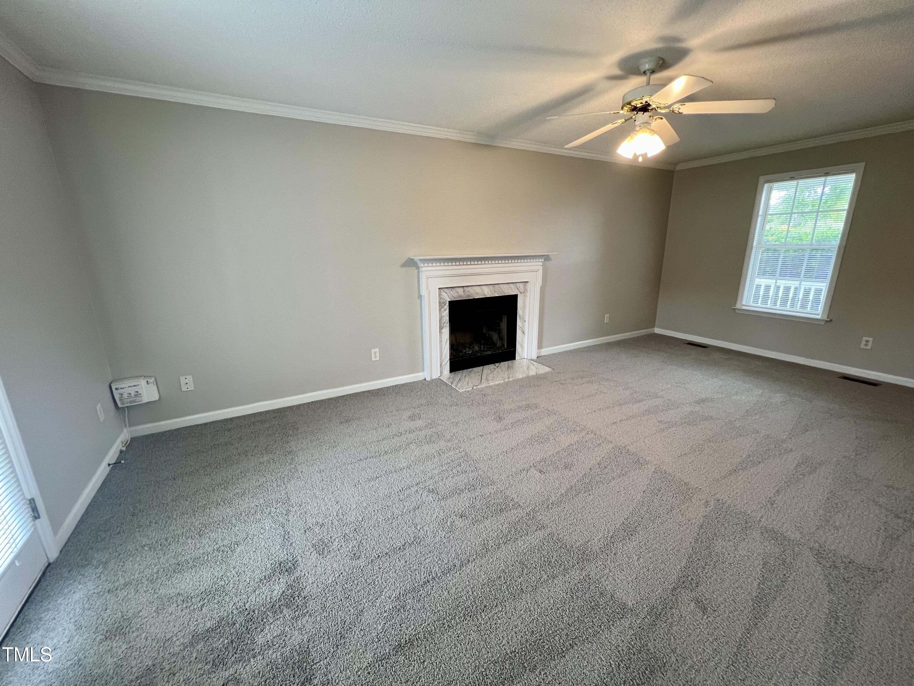 1312 Harvey Johnson Road Raleigh, NC 27603 - Photo 7 of 29 an empty room with windows and fireplace