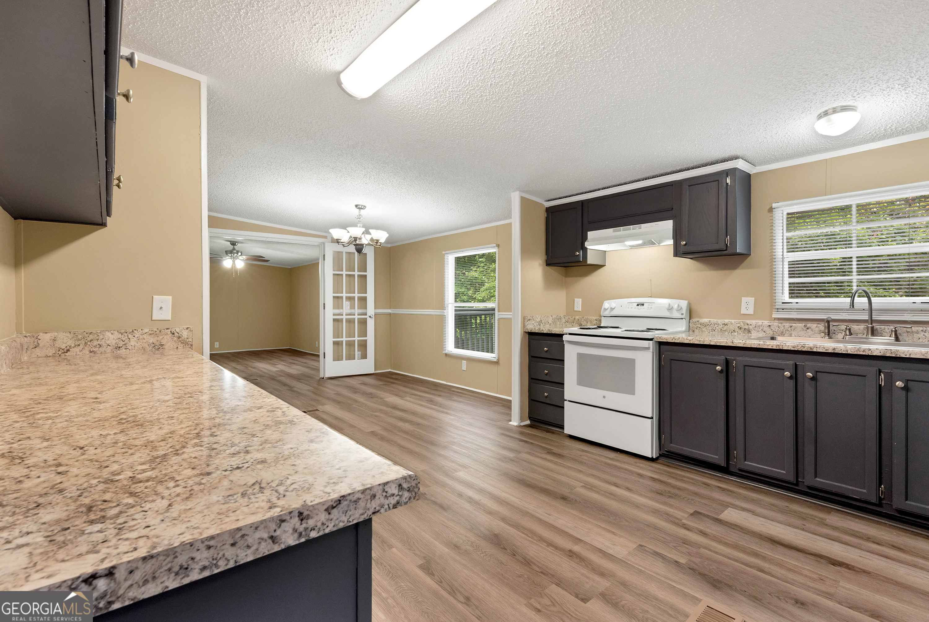 255 Double Branch Road Danielsville, GA 30633 - Photo 11 of 46 a kitchen with stainless steel appliances granite countertop wooden cabinets and sink
