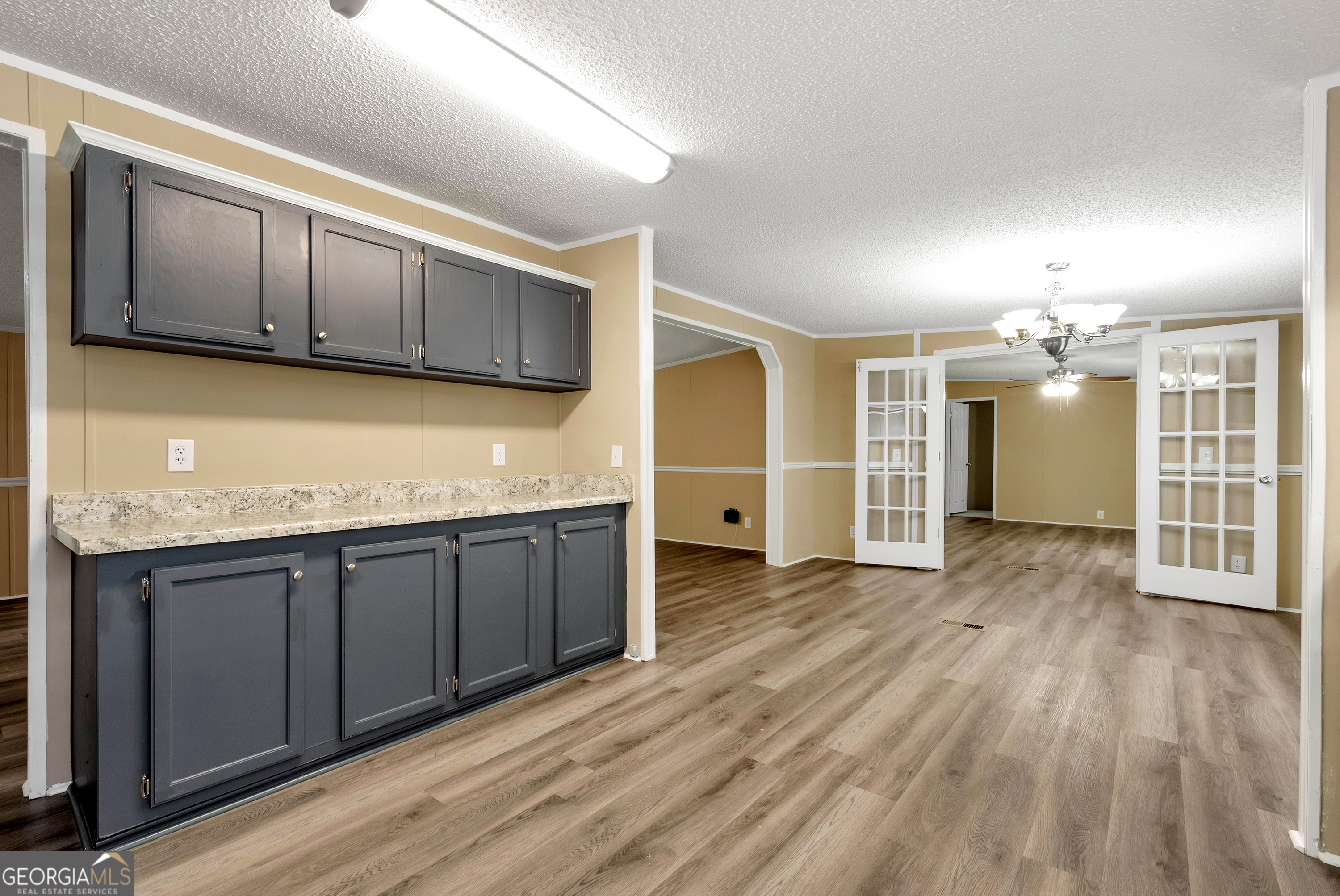 255 Double Branch Road Danielsville, GA 30633 - Photo 13 of 46 a view of a kitchen with a sink and wooden cabinets