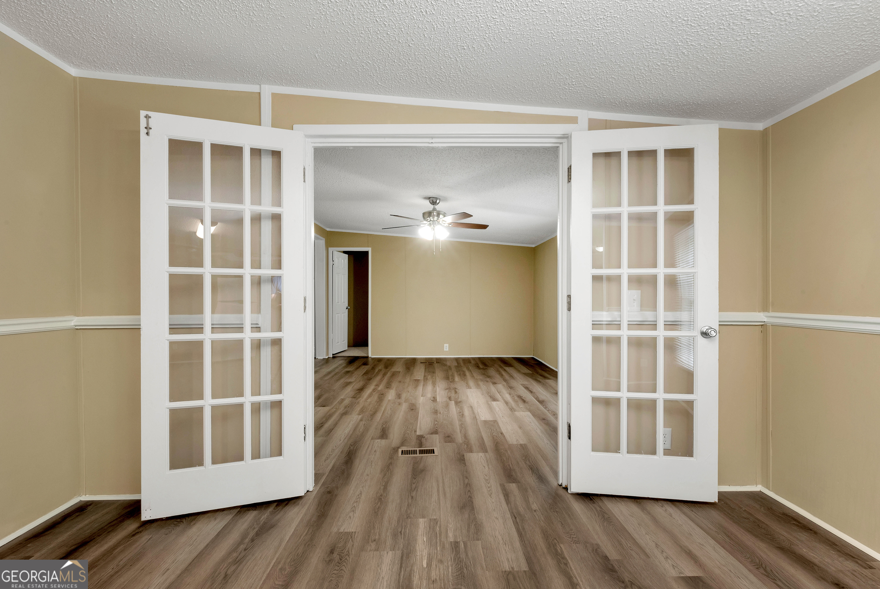 255 Double Branch Road Danielsville, GA 30633 - Photo 14 of 46 a view of an empty room with wooden floor and a window
