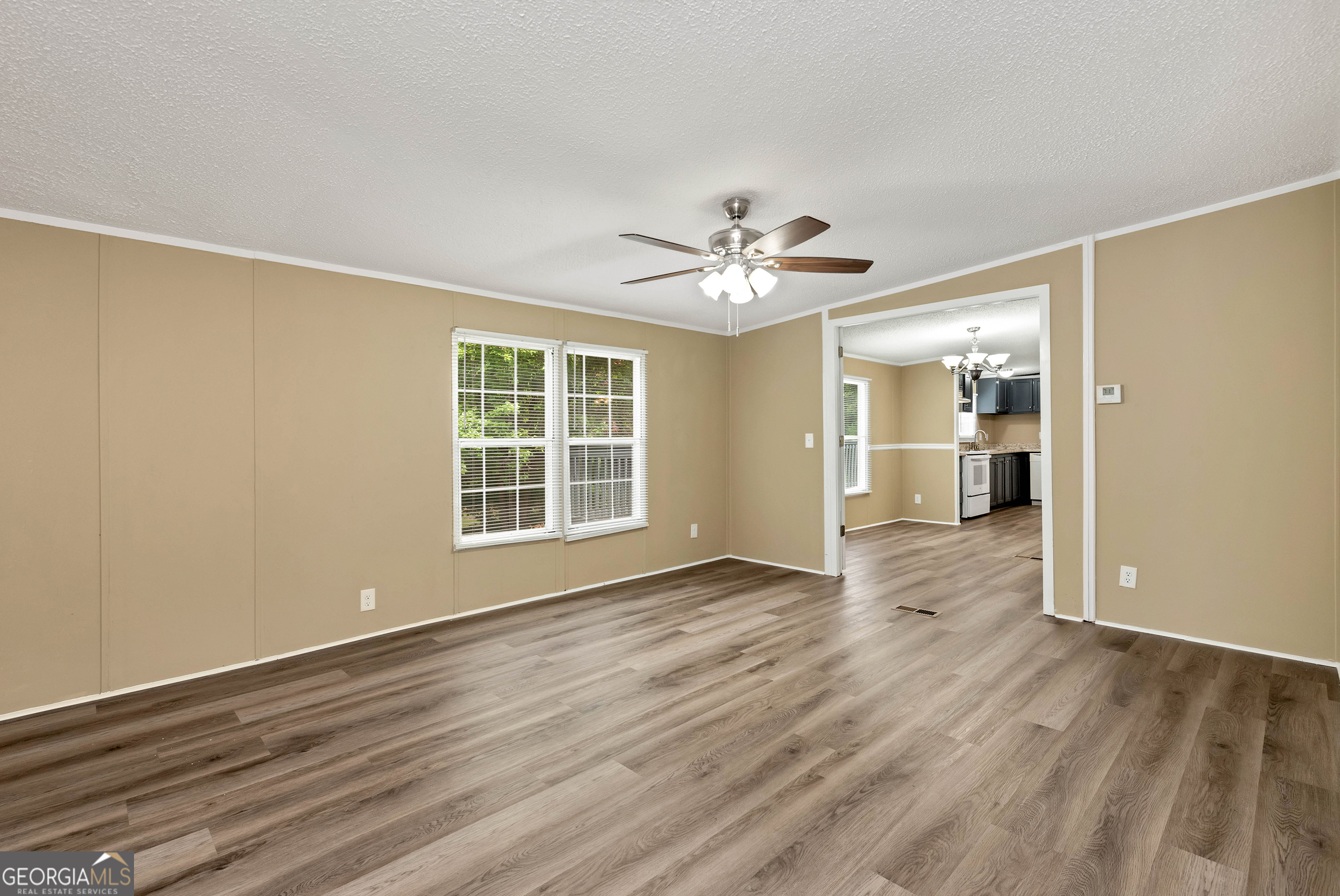 255 Double Branch Road Danielsville, GA 30633 - Photo 22 of 46 a view of an empty room with a window and wooden floor