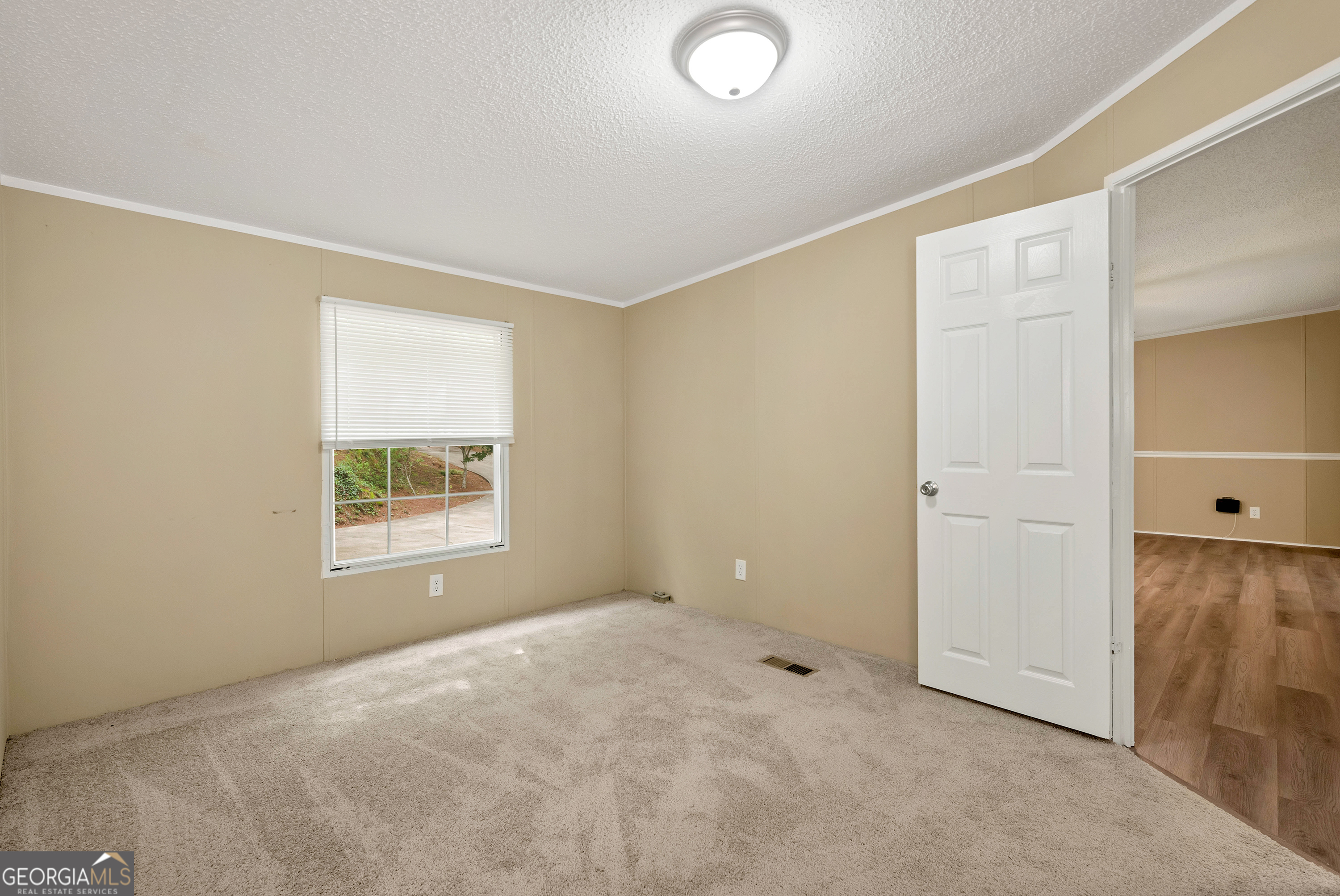 255 Double Branch Road Danielsville, GA 30633 - Photo 25 of 46 an empty room with windows