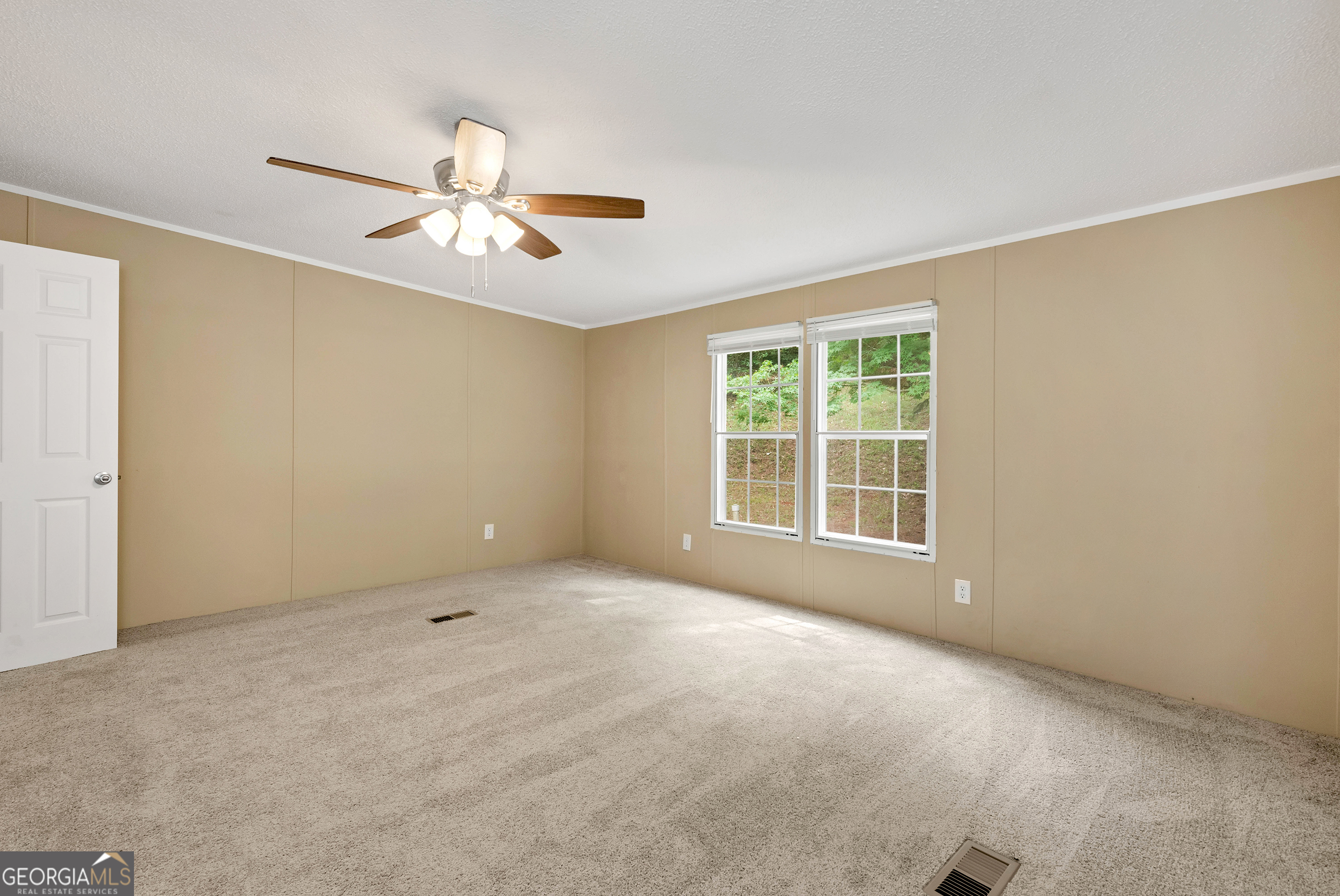 255 Double Branch Road Danielsville, GA 30633 - Photo 26 of 46 a view of a room with a ceiling fan and a window
