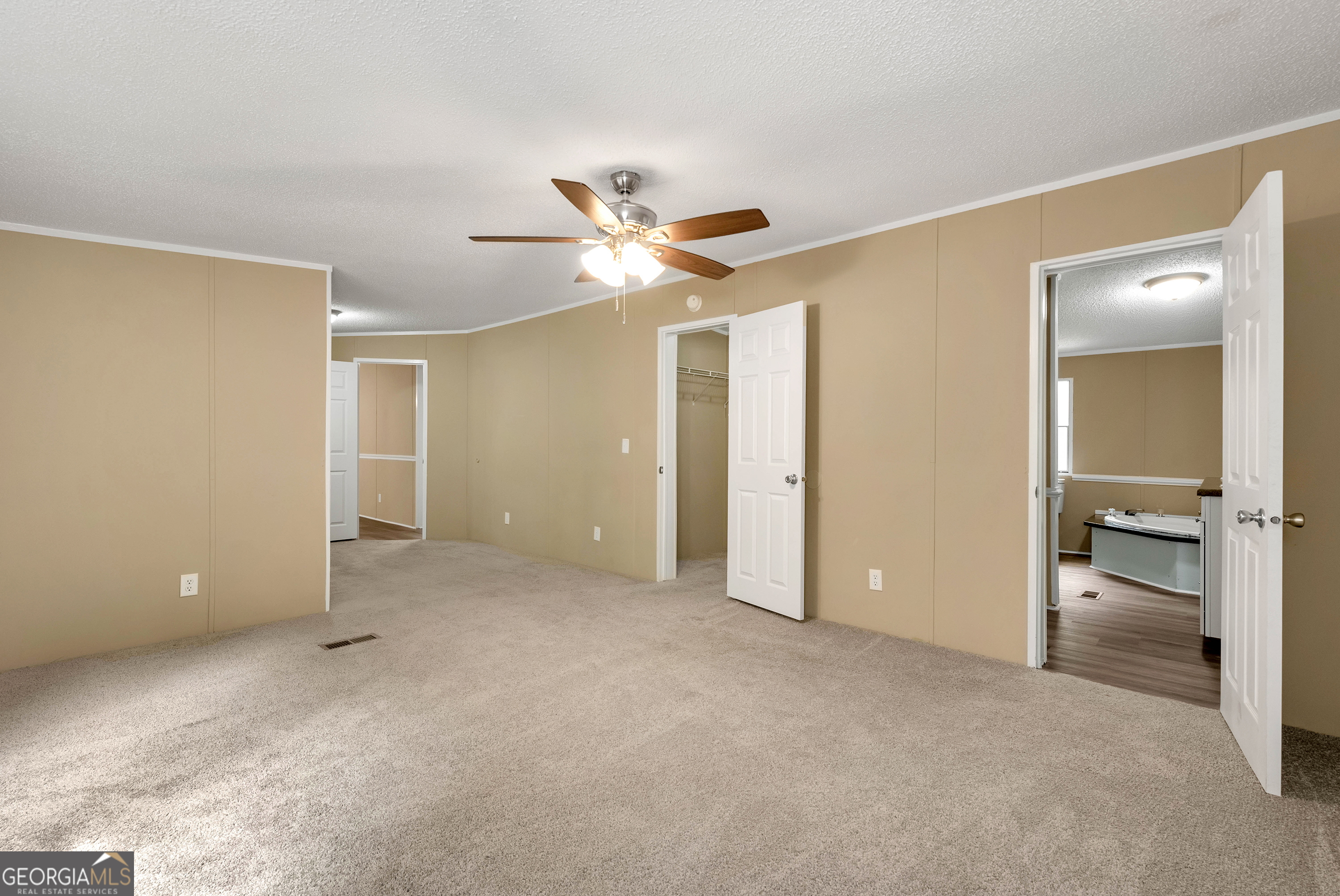 255 Double Branch Road Danielsville, GA 30633 - Photo 27 of 46 an empty room and closet and a ceiling fan
