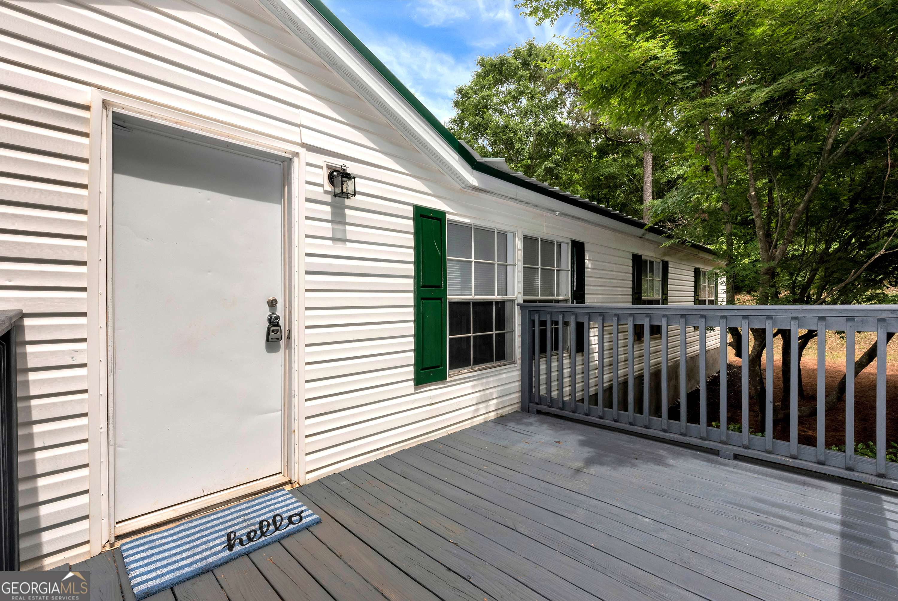 255 Double Branch Road Danielsville, GA 30633 - Photo 3 of 46 a view of deck with wooden floor and fence and a floor to ceiling window