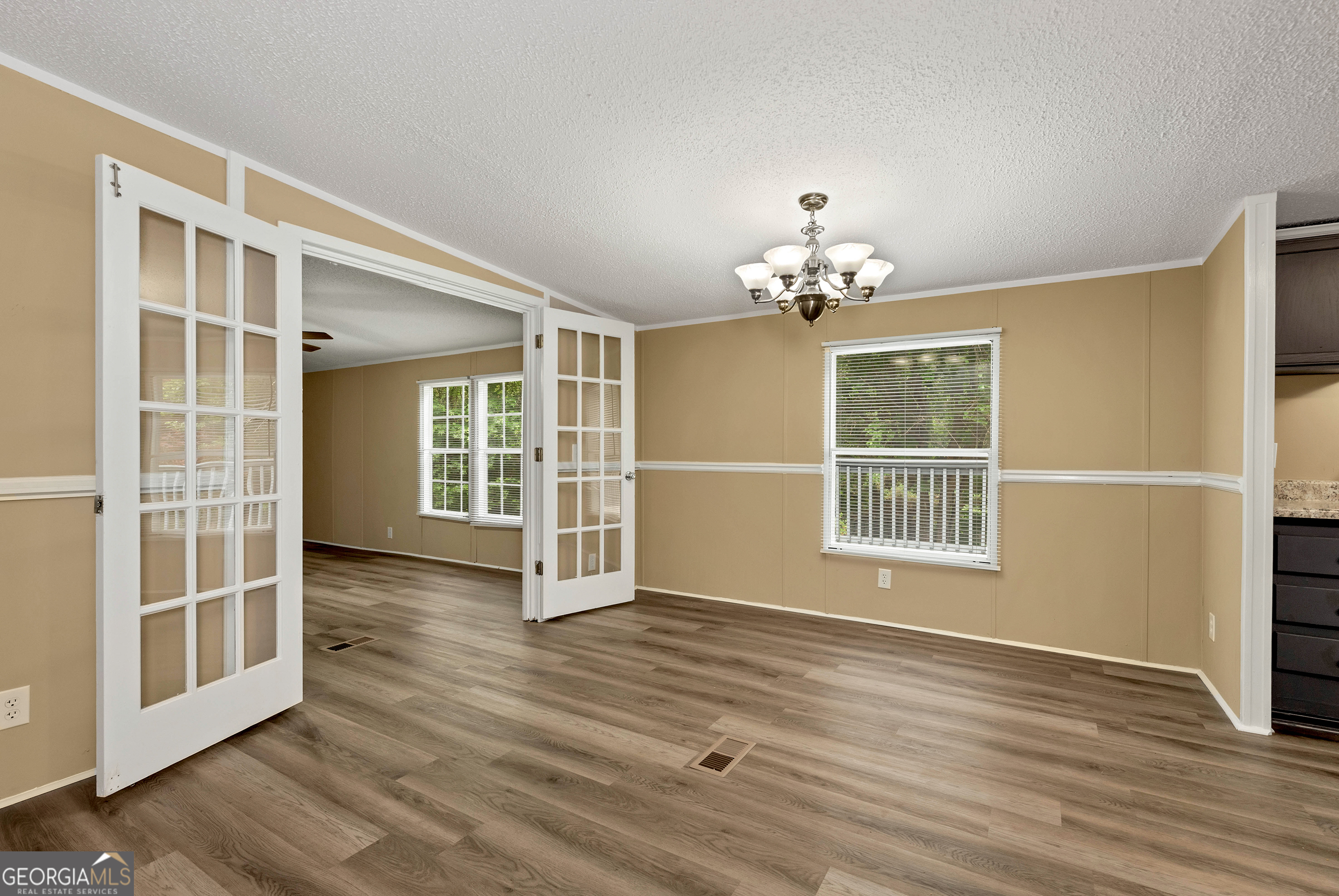 255 Double Branch Road Danielsville, GA 30633 - Photo 8 of 46 a view of an empty room with a window and wooden floor
