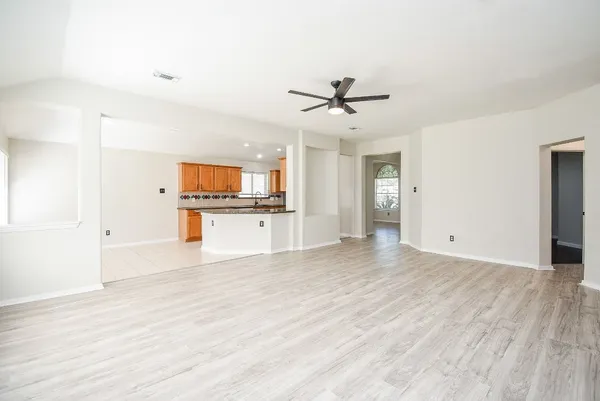 a kitchen with granite countertop a sink a counter top space and cabinets