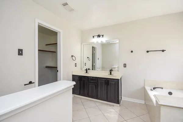a view of a backyard with wooden fence and large trees