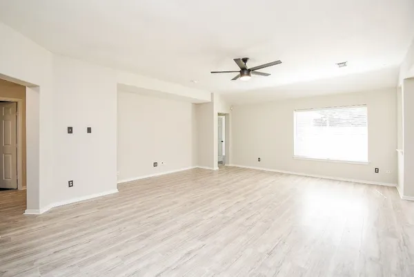 a view of a livingroom with a hardwood floor and a ceiling fan
