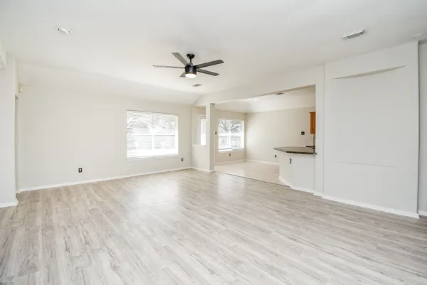a view of a kitchen with a sink and a refrigerator