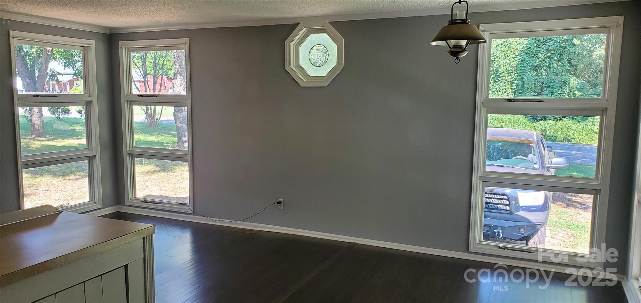 124 Roxie Lane Belmont, NC 28012 - Photo 3 of 6 a view of an empty room with wooden floor and a window