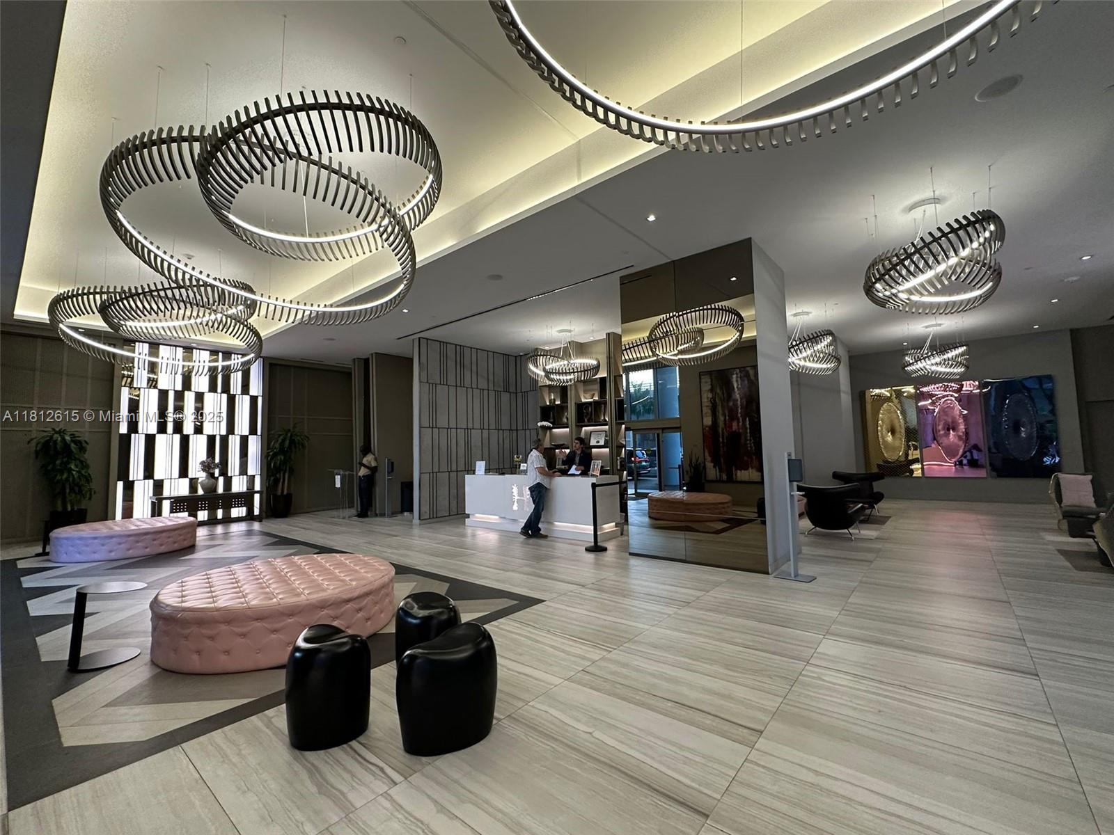 4010 South Ocean Drive, Unit R1705 Hollywood, FL 33019 - Photo 2 of 15 a living room with furniture a ceiling fan and a rug