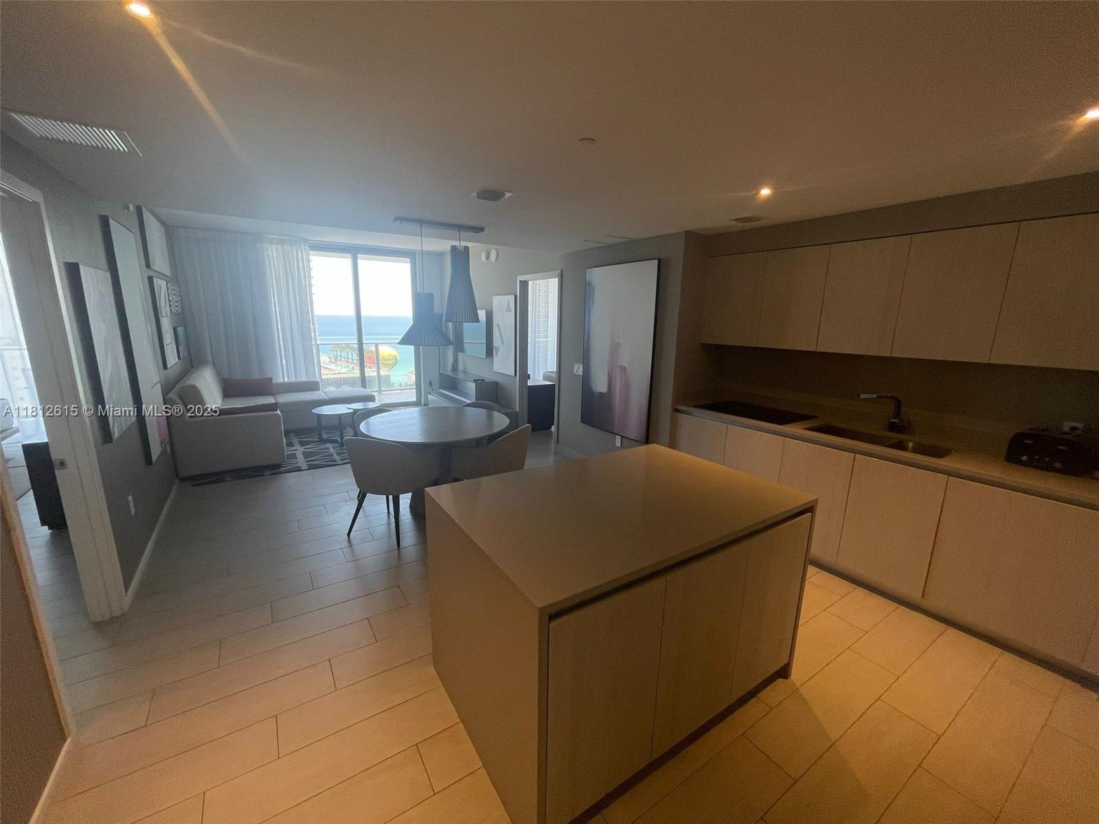 4010 South Ocean Drive, Unit R1705 Hollywood, FL 33019 - Photo 5 of 15 a living room with stainless steel appliances furniture and a kitchen view