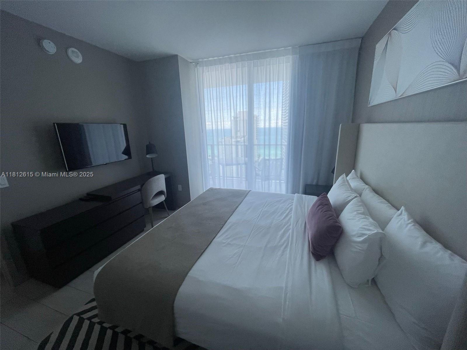 4010 South Ocean Drive, Unit R1705 Hollywood, FL 33019 - Photo 8 of 15 a bedroom with a bed and a window