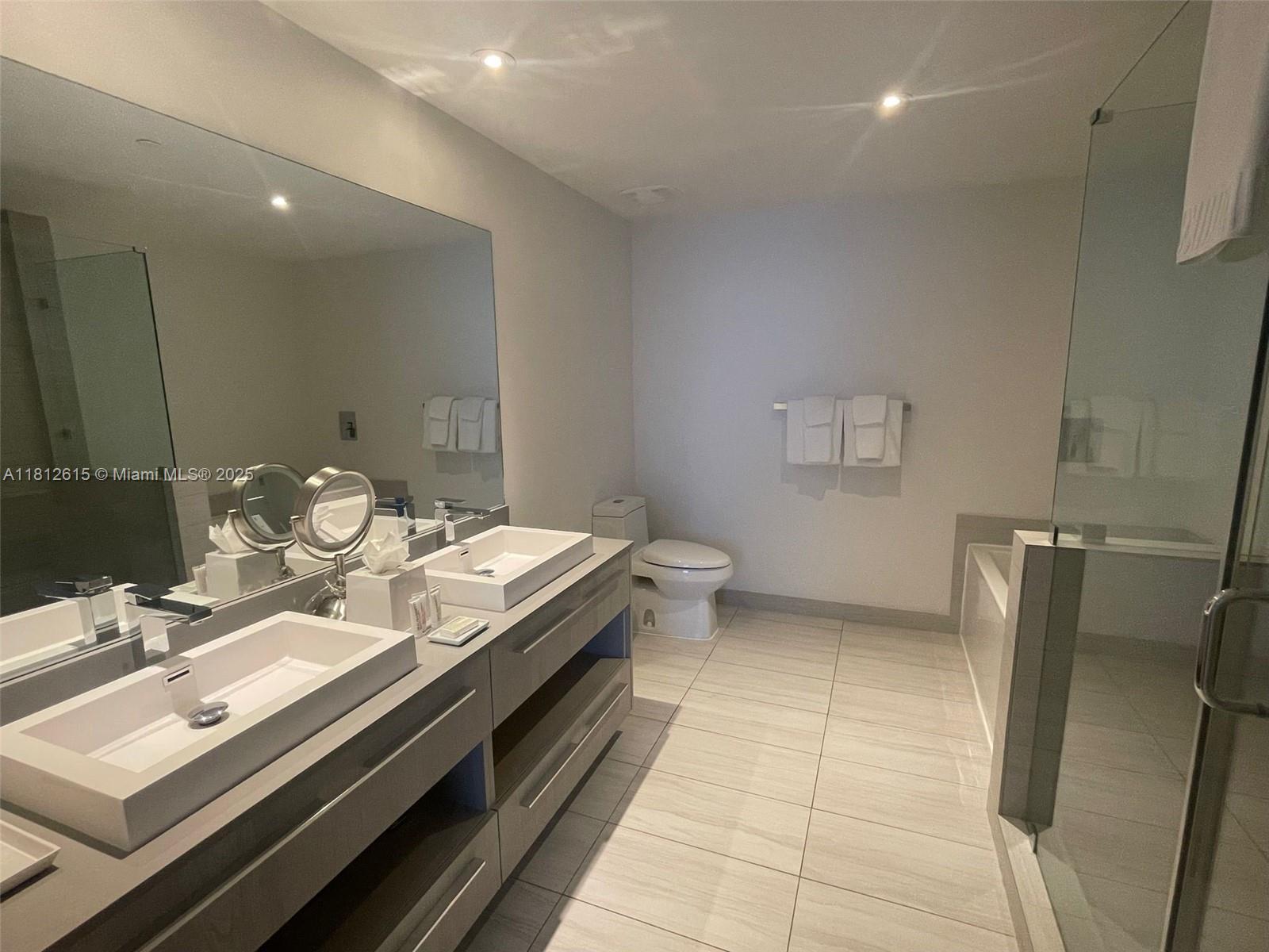 4010 South Ocean Drive, Unit R1705 Hollywood, FL 33019 - Photo 9 of 15 a bathroom with a double vanity sink and a mirror