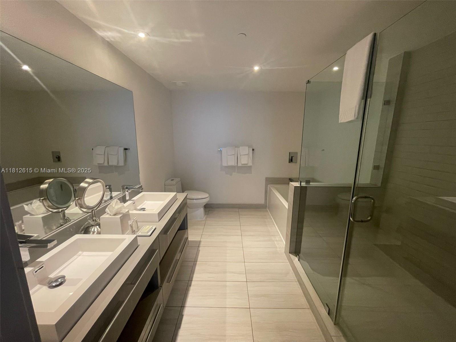 4010 South Ocean Drive, Unit R1705 Hollywood, FL 33019 - Photo 10 of 15 a bathroom with a double vanity sink and mirror